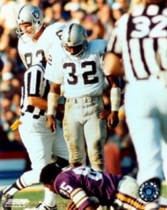 Raiders legend Jack Tatum stands over a Vikings WR he knocked the helmet off of with a vicious hit.