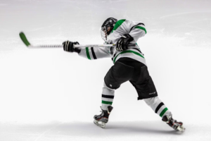 Dynamic hockey player unleashing a powerful shot on goal