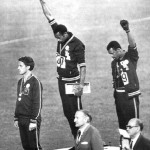 Athletes Tommie Smith and John Carlos raise their fists in a gesture of solidarity