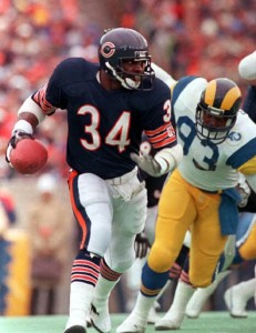 Walter Payton is pursued by the Rams defense in Chicago, in this Jan. 12, 1986 photo. Payton, whose aggressive, elusive style made him the NFL's all-time rushing leader and took Chicago to its only Super Bowl victory, died Monday Nov. 1, 1999. He was 45. Ram defender is unidentified. (AP Photo/John Stewart)