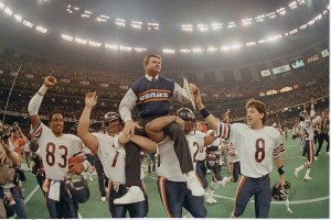 ** FILE ** Chicago Bears head coach Mike Ditka is carried off the field by Steve McMichael, left, and William Perry after the Bears win Super Bowl XX in New Orleans, La., in this Jan. 26, 1986 file photo. The Bears' Willie Gault (83) and Maury Buford (8) join in celebrating their 46-10 victory over the New England Patriots. (AP Photo/Phil Sandlin)