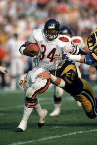 ANAHEIM, CA - NOVEMBER 6: Running back Walter Payton #34 of the Chicago Bears tries to break away from a tackle by Los Angeles Rams linebacker Jim Collins #50 during a game at Anaheim Stadium on November 6, 1983 in Anaheim, California. The Rams won 21-14. (Photo by George Rose/Getty Images)