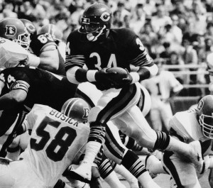 Walter Payton of the Chicago Bears rushes for gain of eight yards during first quarter action against the Denver Broncos at Chicago's Soldier Field, Sept. 9, 1984. (AP Photo/Charles Bennett)