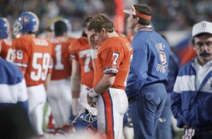 Denver Broncos quarterback John Elway stands dejected on the sidelines during final two minutes of Super Bowl game with Washington Redskins, Sunday, Jan. 31, 1988 in San Diego. Elway was sacked 5 times for 50 yards and was held to 14 completions in 38 attempts. Redskins won, 42-10. (AP Photo/Ed Andrieski)