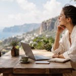 woman working by the sea and mountains with a laptop